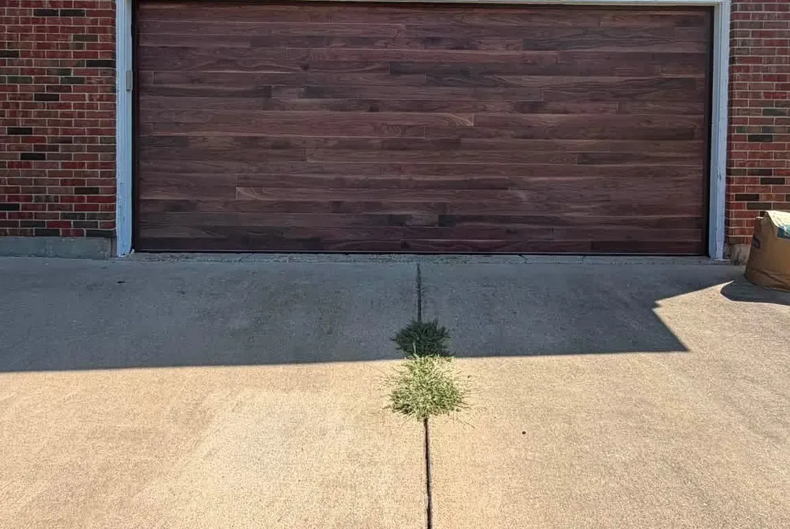 A new wood-look garage door on a brick house
