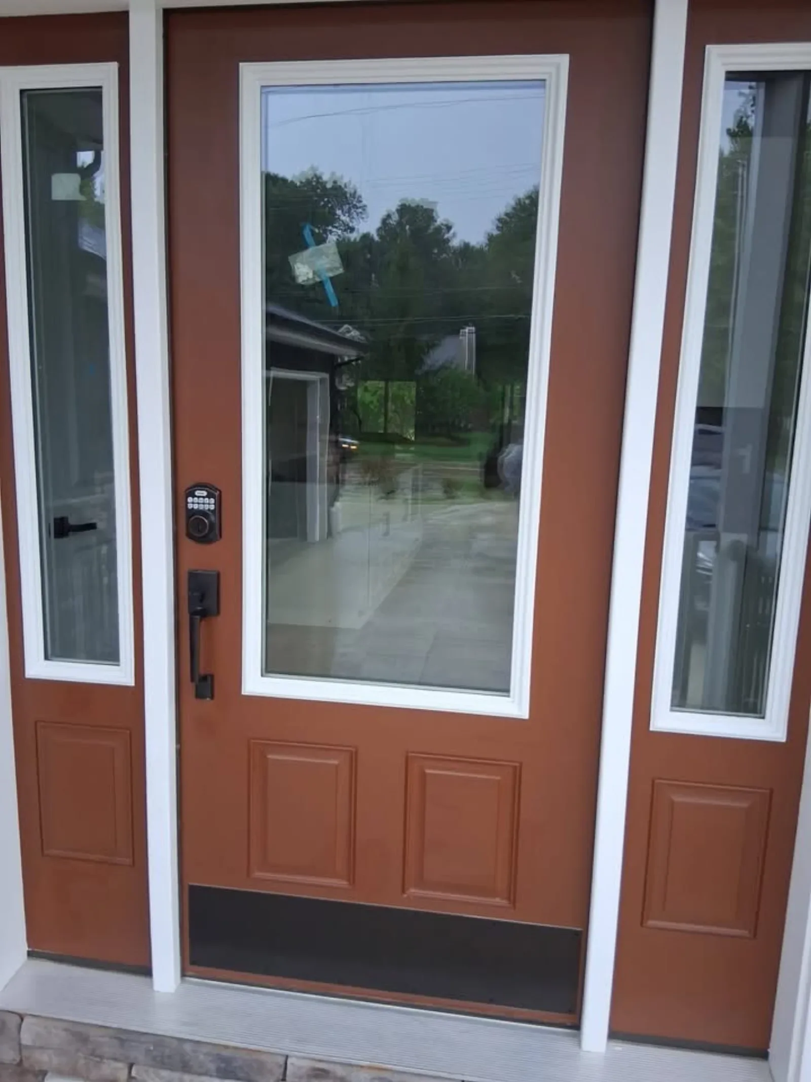 A new fiberglass entry door with sidelites