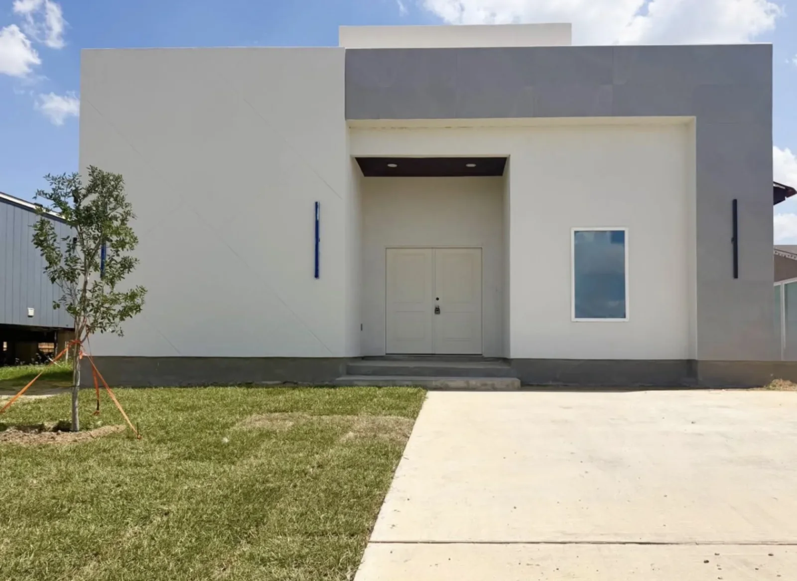 A double entry door on a modern stucco house