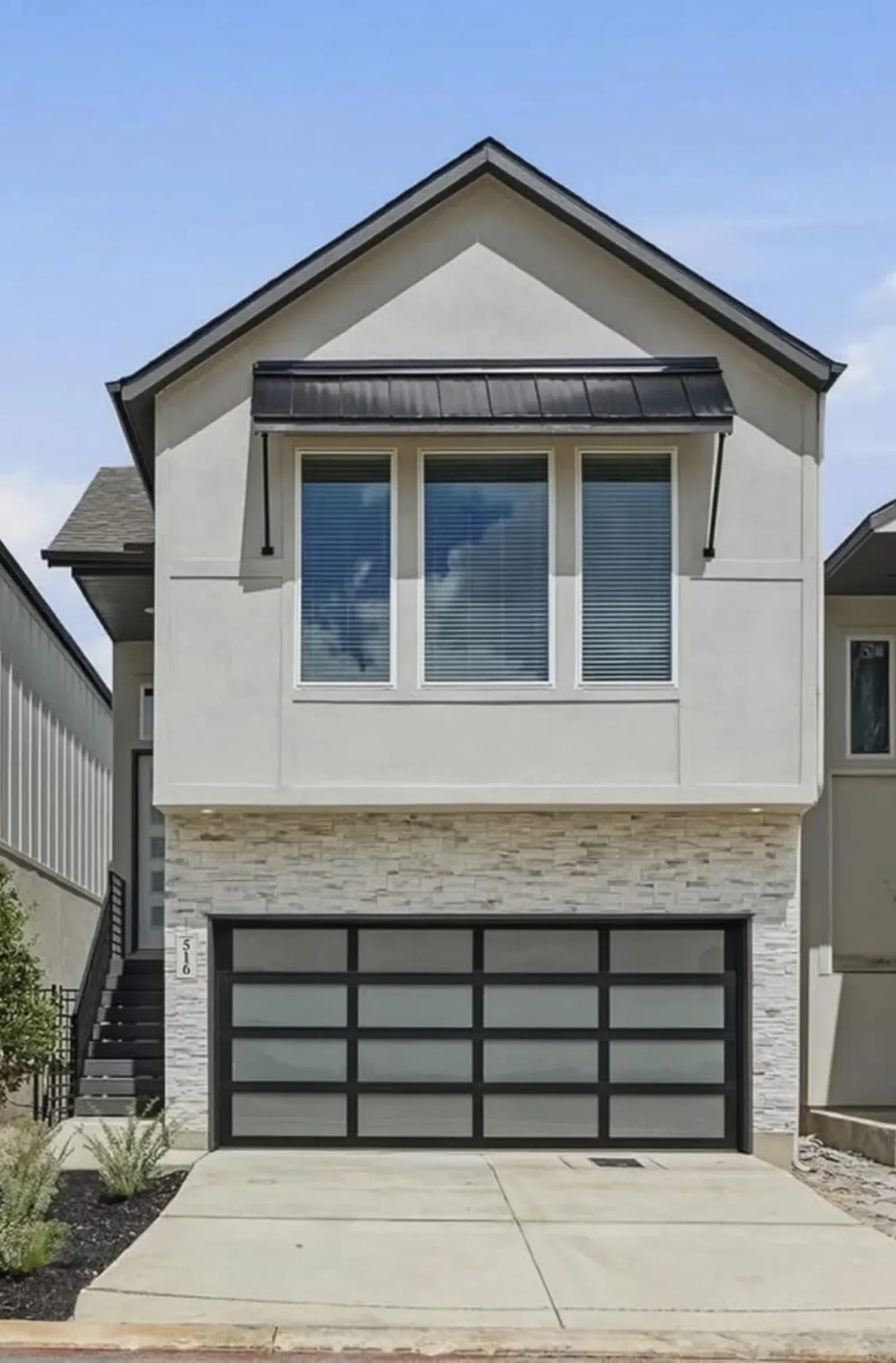 A full-view glass garage door on a modern house