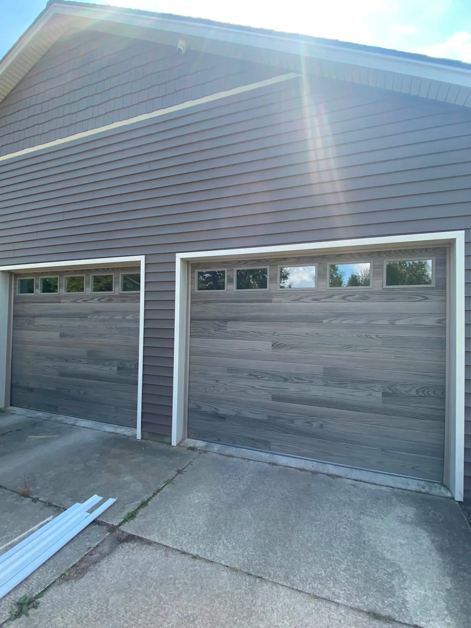 Two new gray wood-look garage doors