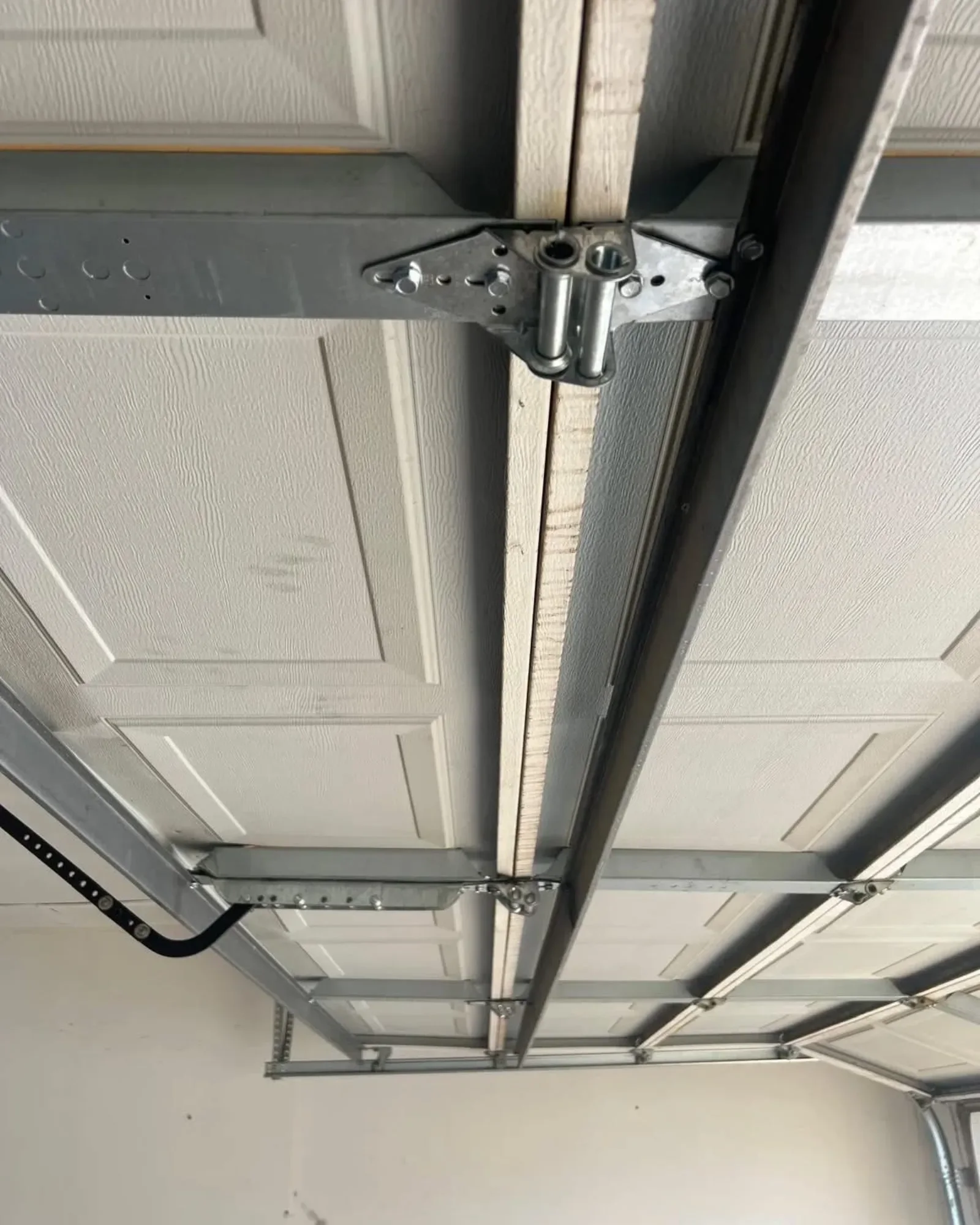 A hinge and the track on a garage ceiling