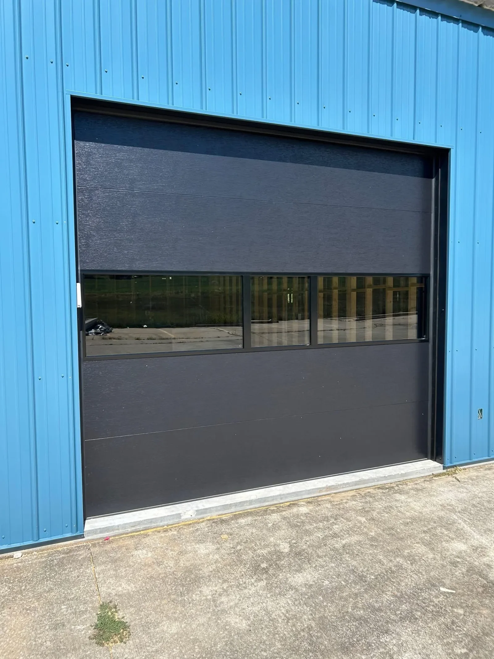 A commercial sectional door with a row of windows