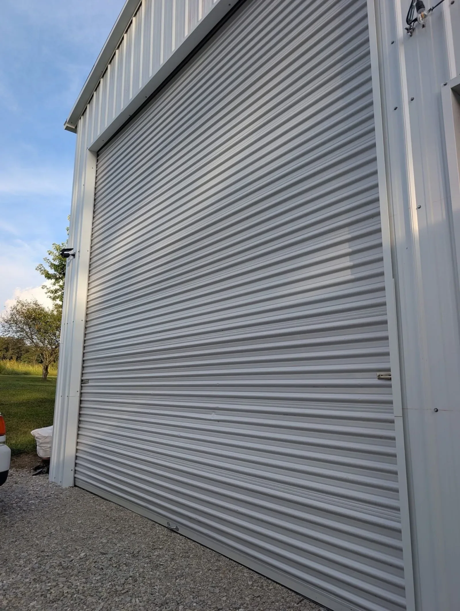 A tall rolling steel door on a metal building