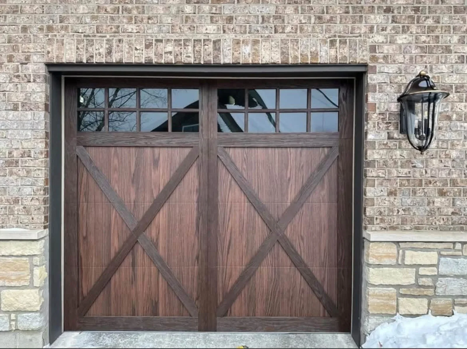 A wood-look carriage garage door with X bracing