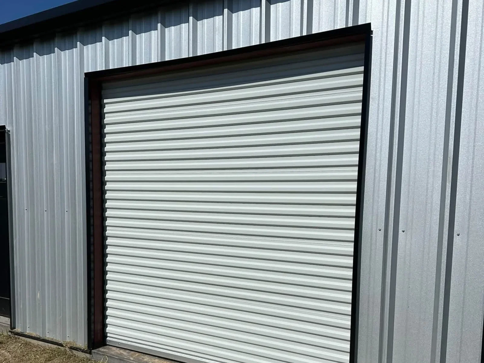 A rolling steel door on a metal building