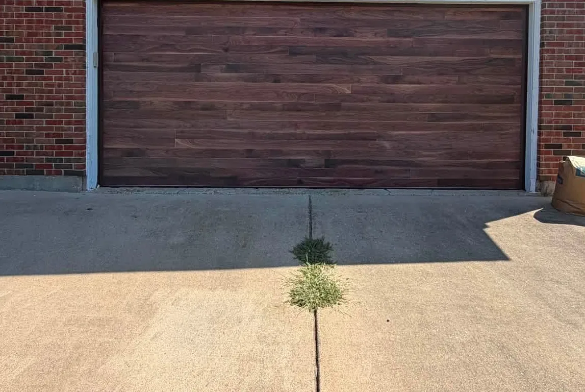 A new wood-look garage door on a brick house