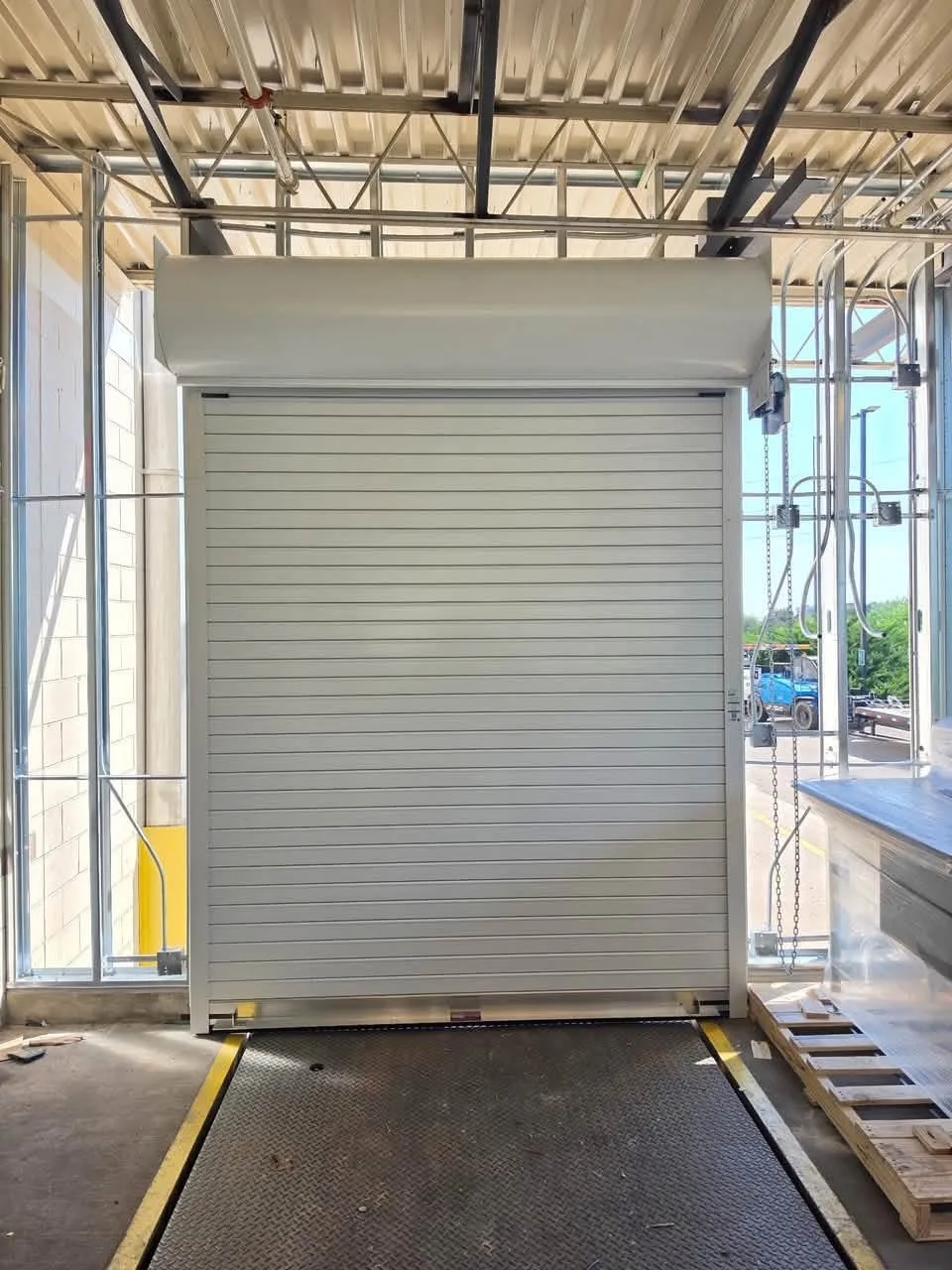 A rolling steel door over a dock leveler